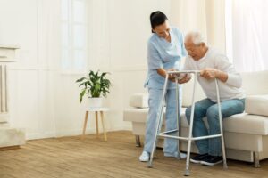 caregiver assisting elderly man