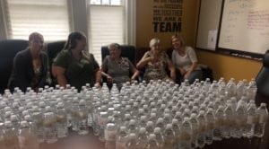 Our Team taking a break from prepping water bottles for the Alzheimer's Walk