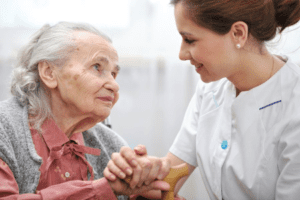 Caregiver holding hands with Eldery Woman